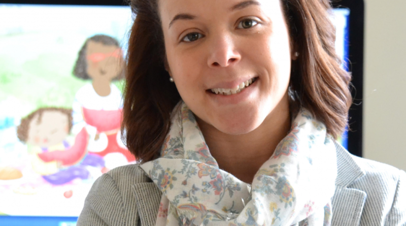 Lady smiling to camera with medium length brown hair