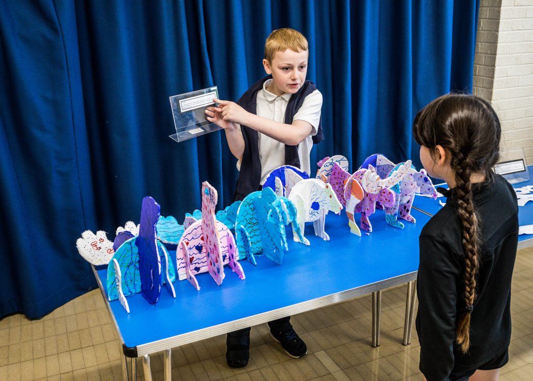 Young boy shares information about the wildlife in the arctic using a tablet and models created by the pupils.