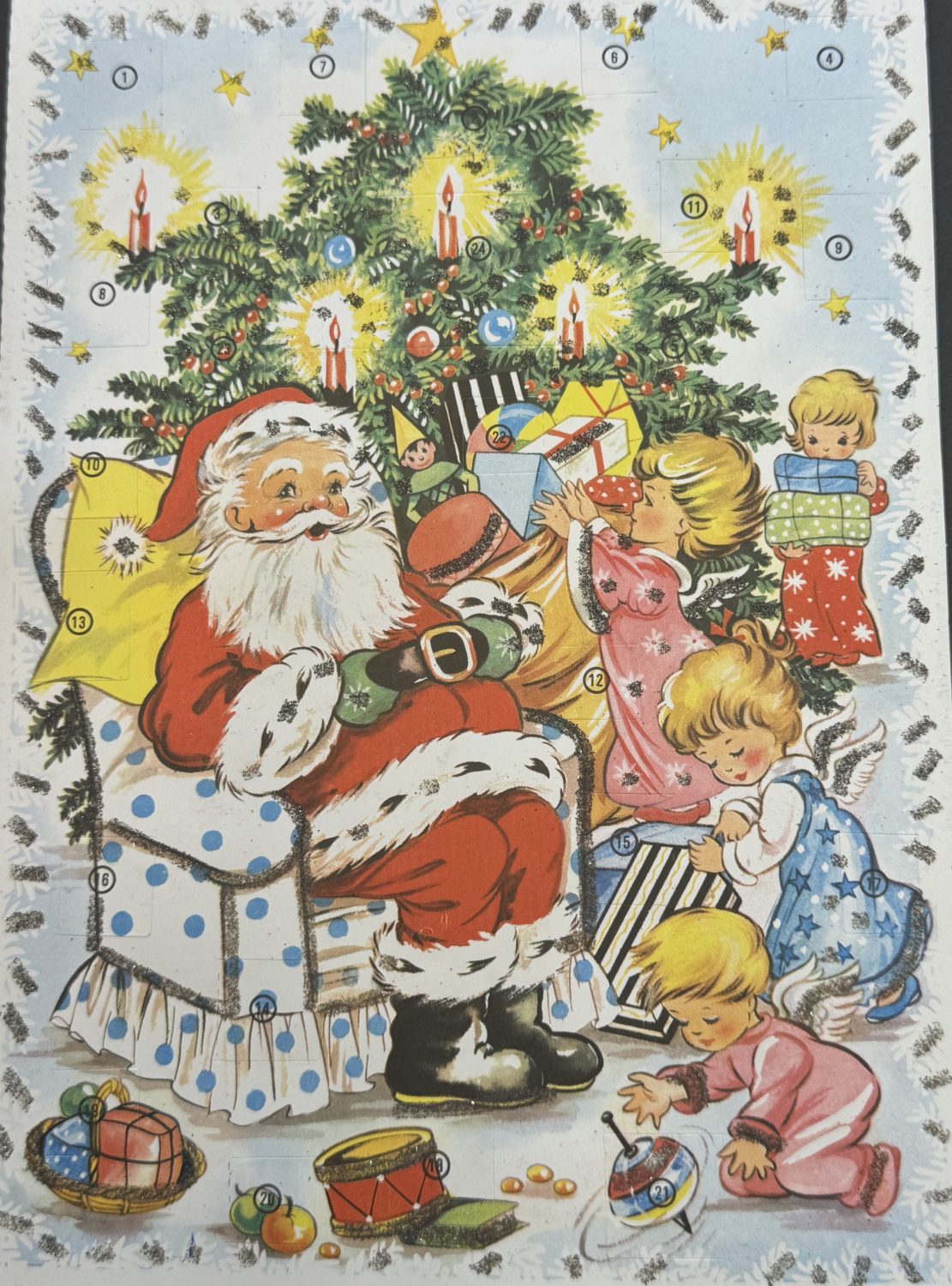 An early advent calendar from Museum of Hartlepool's collection. The calendar shows Santa Clause sitting in an arm chair, surrounded by children with presents. There is also a Christmas tree.